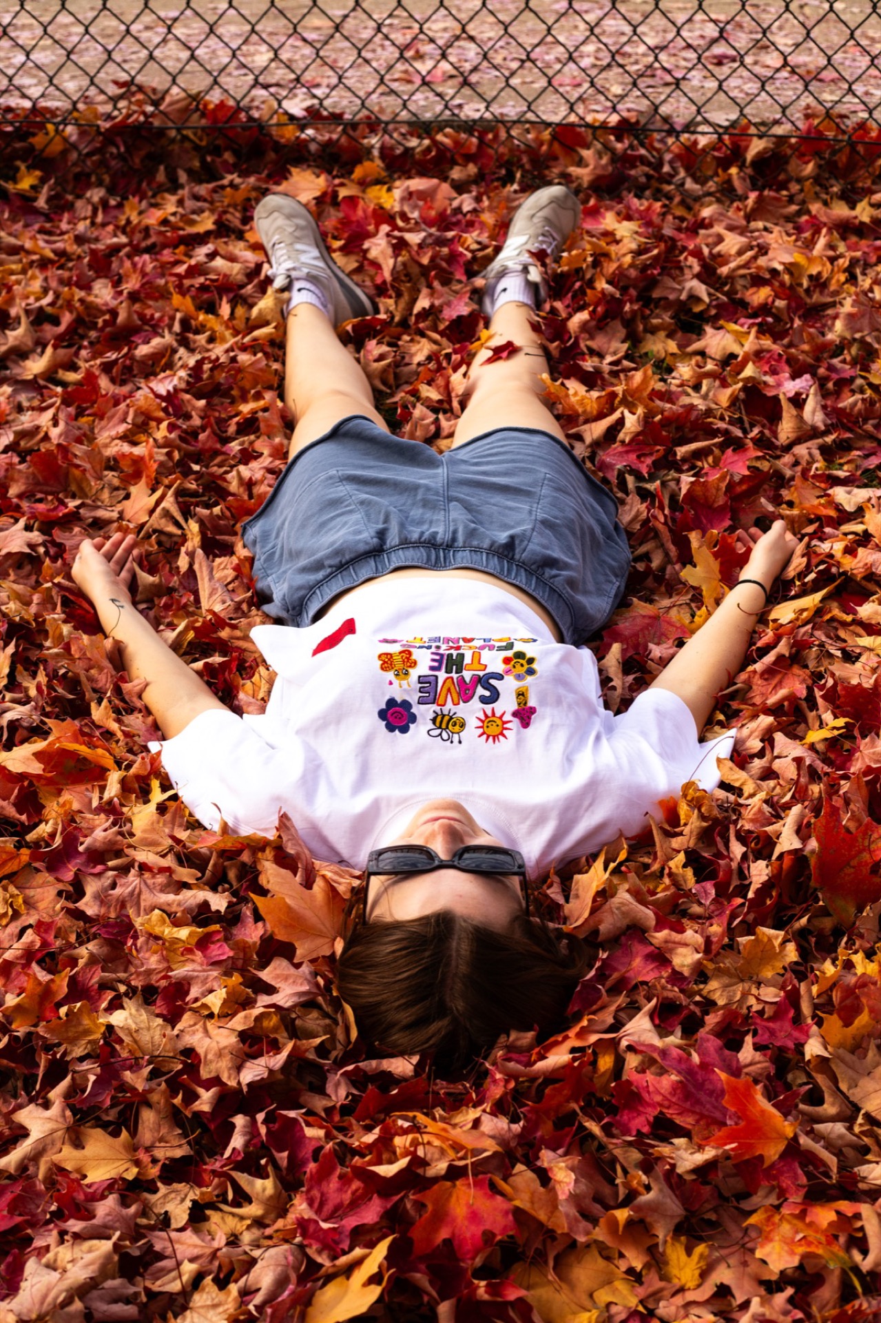 Person lying in autumn leaves