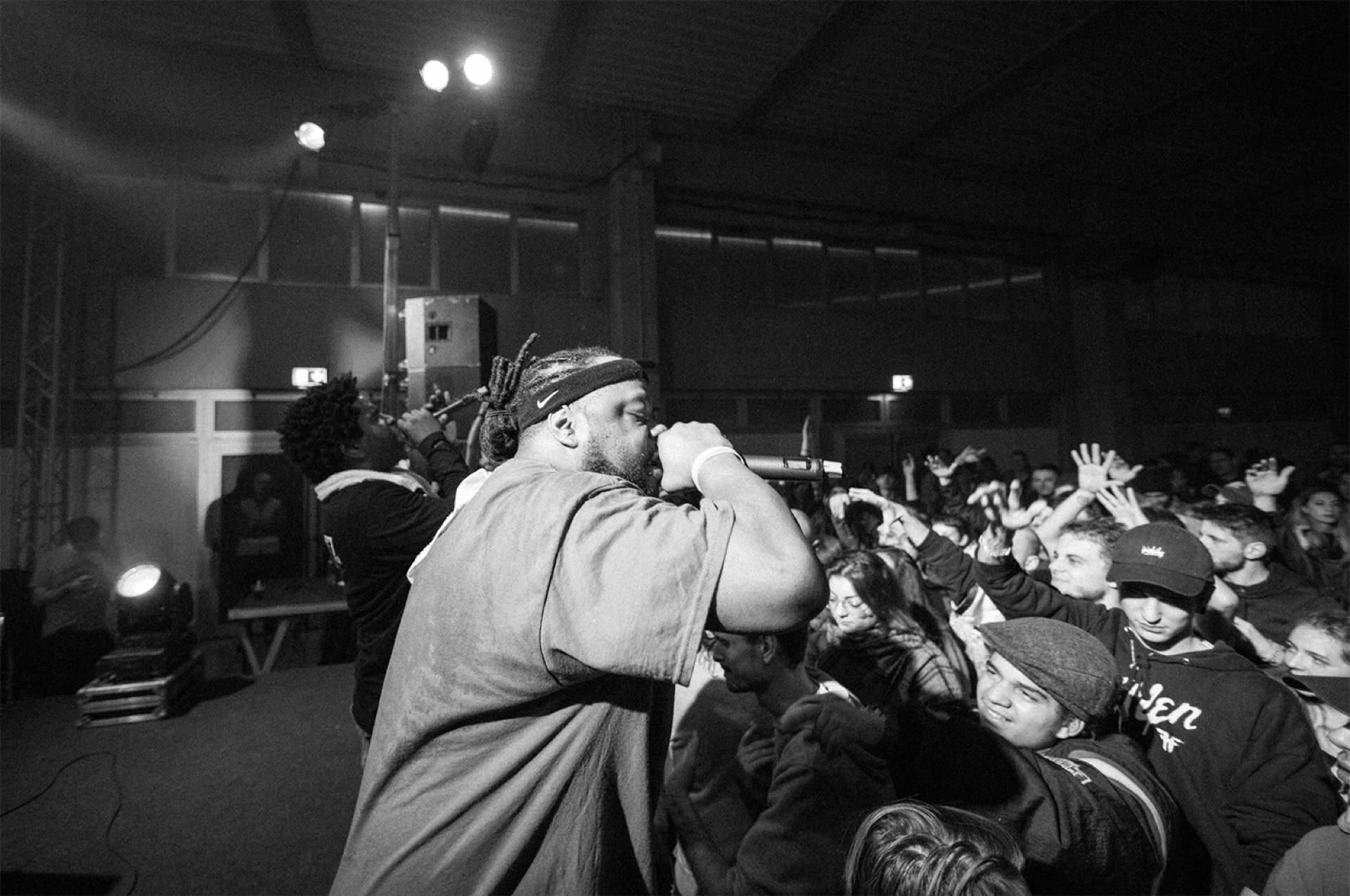 Hip hop concert, performer on stage with crowd