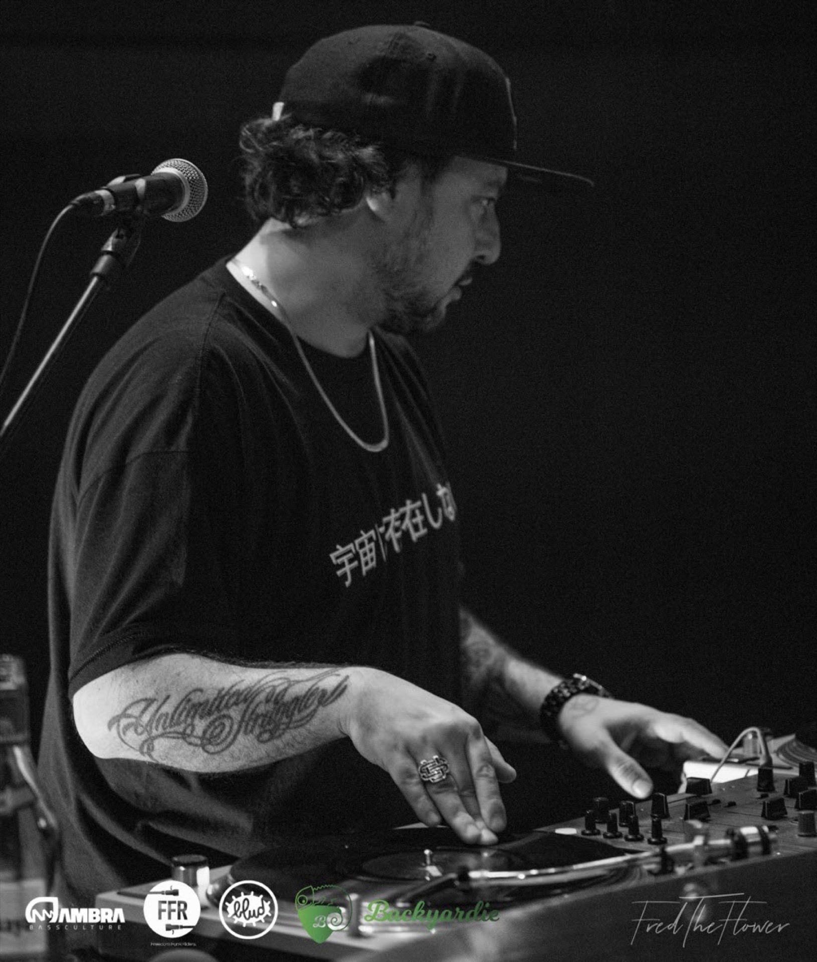DJ on turntables at a hip hop show, black and white