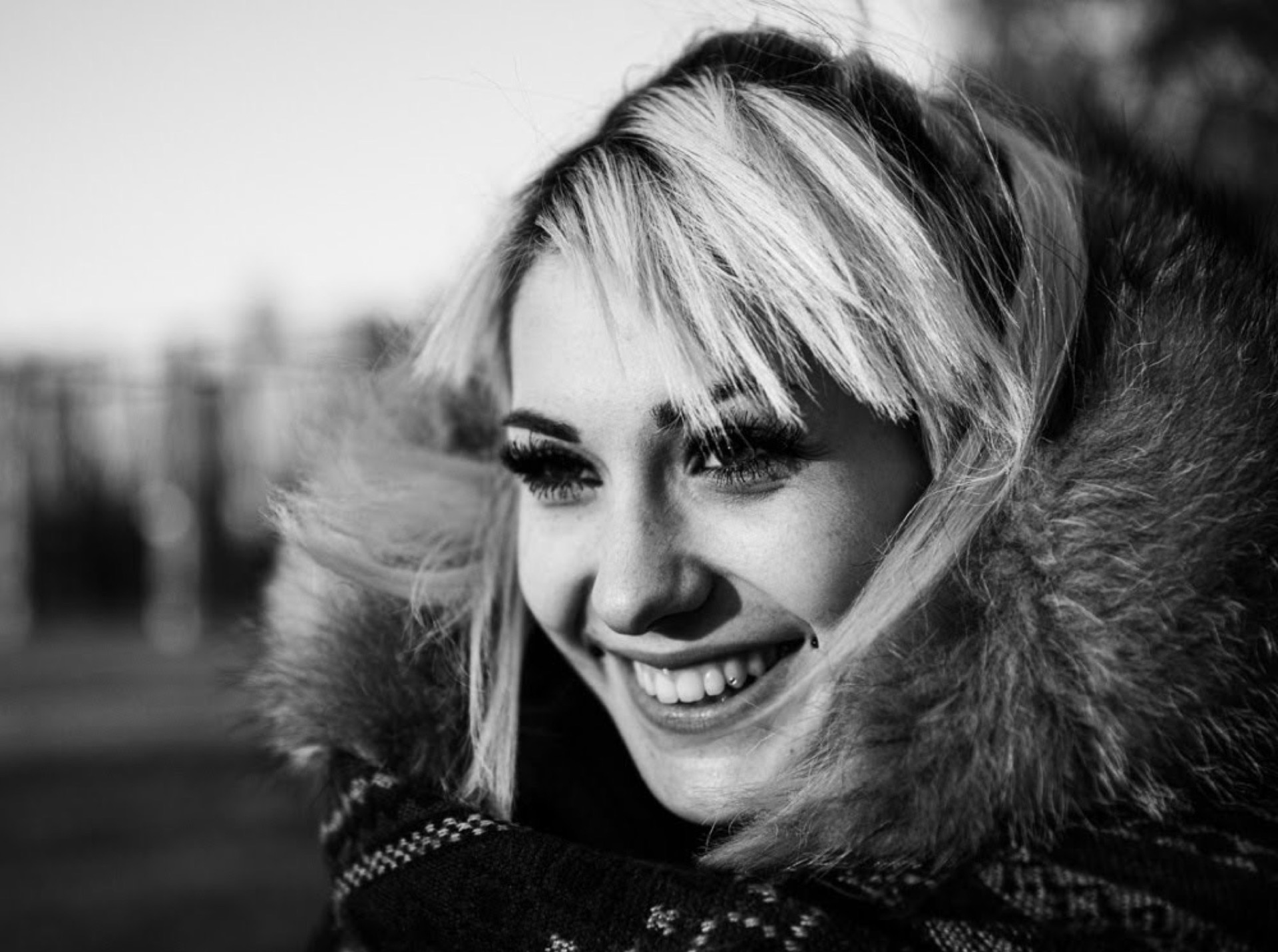 Blonde woman smiling, black and white portrait