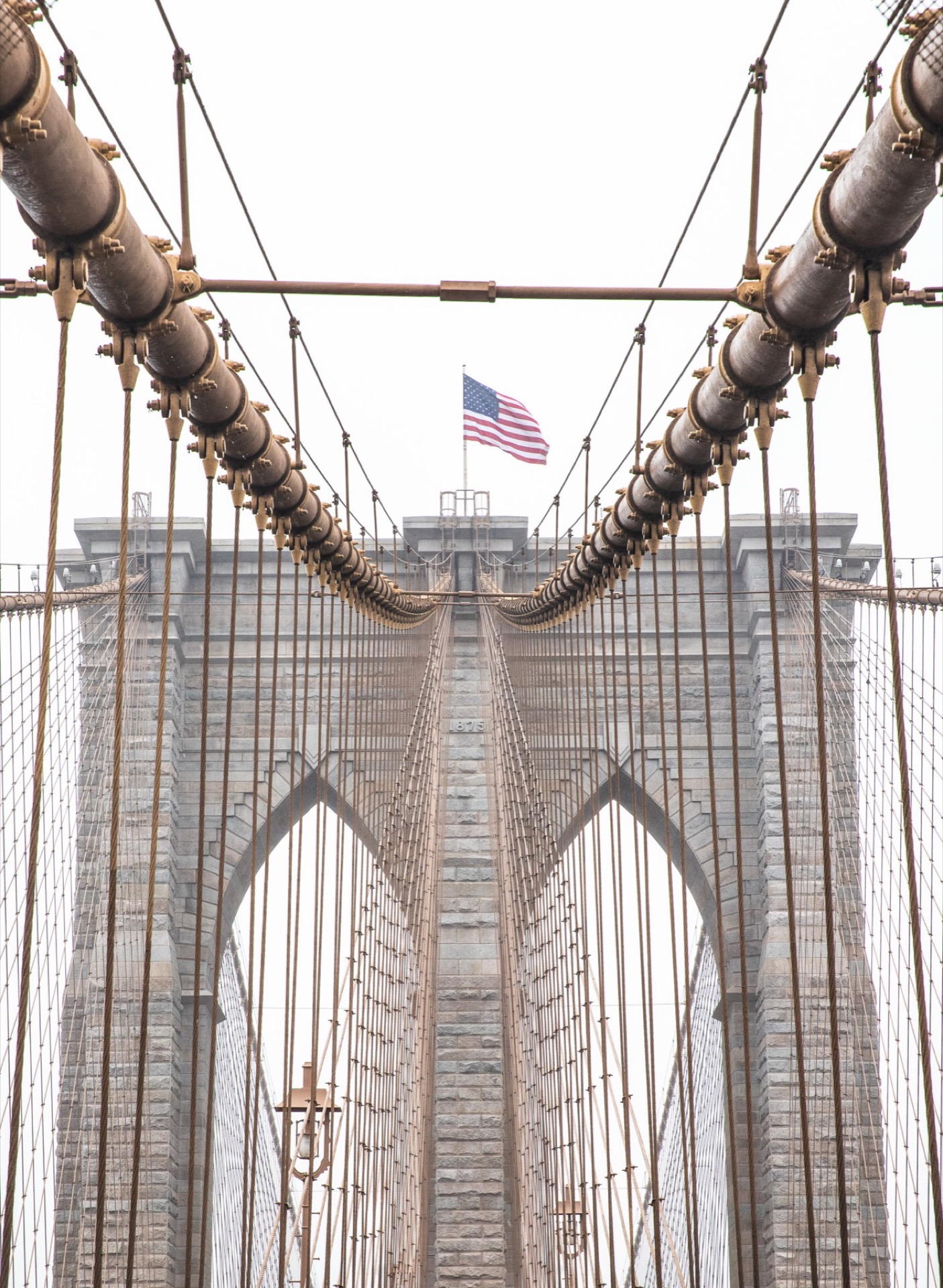 Brooklyn Bridge cables and American flag, New York