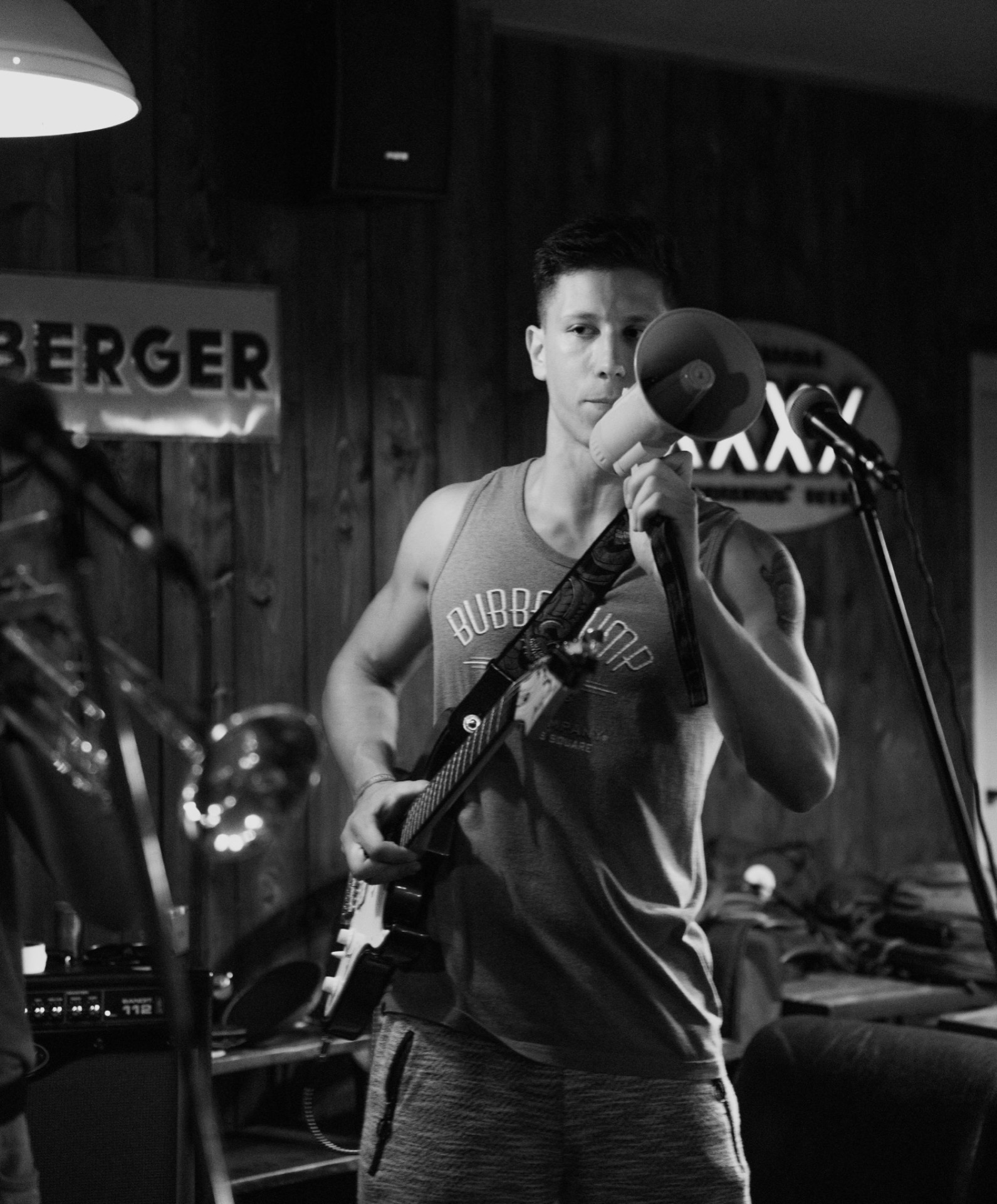 Guitarist performing with a megaphone, black and white