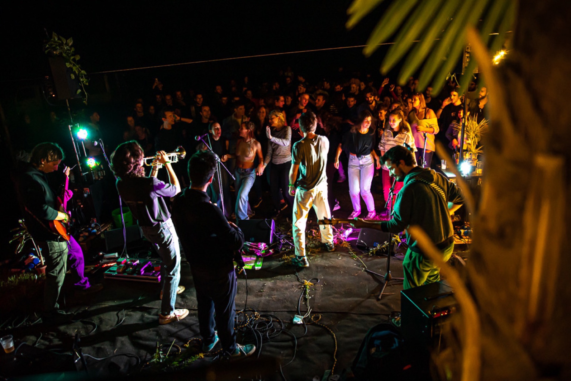 Outdoor concert at night with coloured stage lights